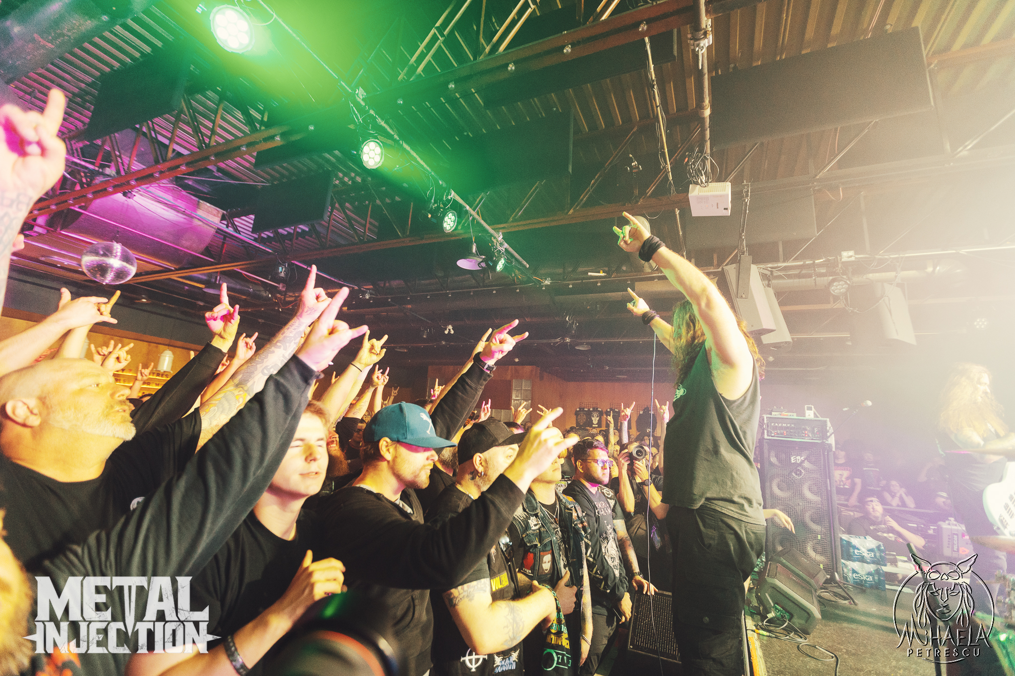 Unearth performing a high-energy live metalcore show, with band members playing guitar, bass, and drums on stage under concert lighting.