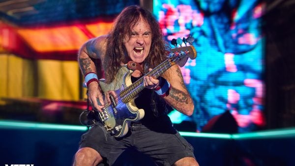Steve Harris of Iron Maiden performing live on stage with his signature bass guitar and energetic stage presence