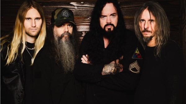 Studio promotional photo of Evergrey, photographed by Patric Ullaeus, featuring the band members posed together against a dark, atmospheric background.