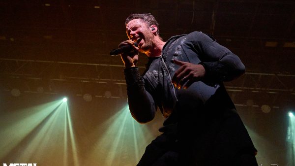 Tommy Karevik, vocalist of symphonic metal band Kamelot, performing live on stage with dramatic lighting and intense expression