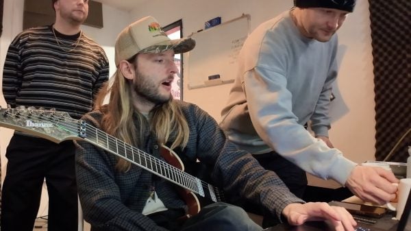 Malevolence band members in the studio tracking a song for World of Warcraft: Midnight, with instruments and recording equipment visible