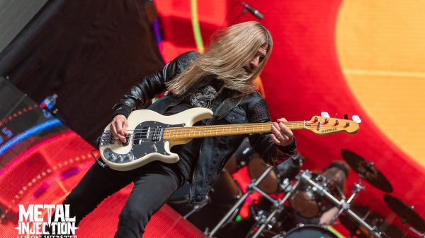 James LoMenzo playing bass on stage during a live Megadeth concert performance.