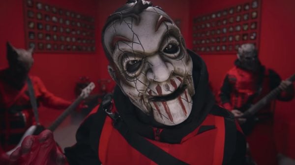 Mushroomhead performing "Fall In Line" live on stage, with lead singer in mask and dynamic lighting.