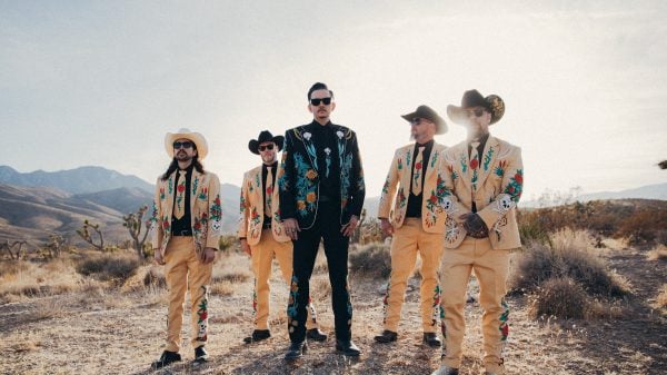 Promotional photo of the metal band SpiritWorld, featuring all members posed together in studio or outdoor setting