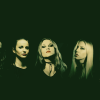 Promotional posed photo of the all-female thrash metal band Nervosa, featuring Prika Amaral (vocals, guitars), Helena Kotina (guitars), Hel Pyre (bass), Emmelie Herwegh (bass), and Michaela Naydenova (drums).